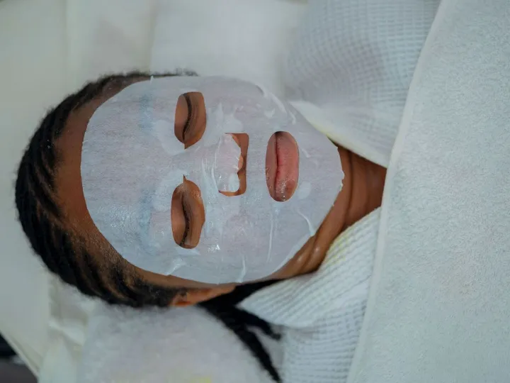 Woman enjoying a rejuvenating facial mask treatment at a spa