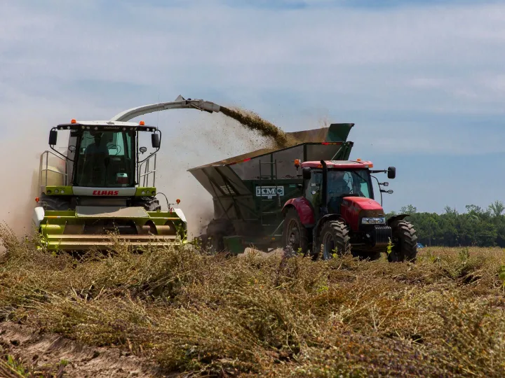 Tractors working in a field during harvest in