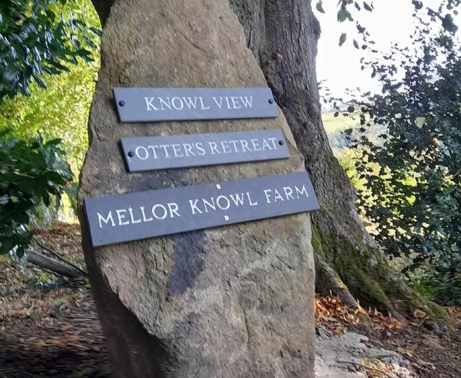 The stone signpost to Otters Retreat at the entrance to Mellor Knowl Farm
