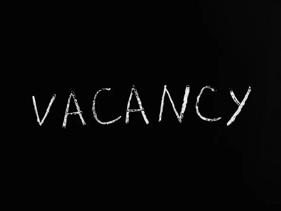 Handwritten chalk text displaying 'vacancy' on a