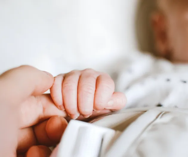 person-holding-baby-s-hand-2721581