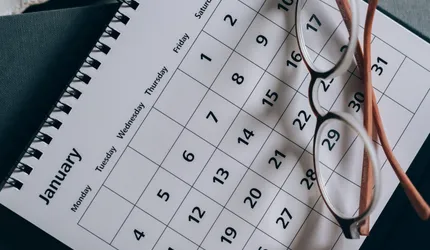 Brown-Framed Eyeglasses on a Calendar