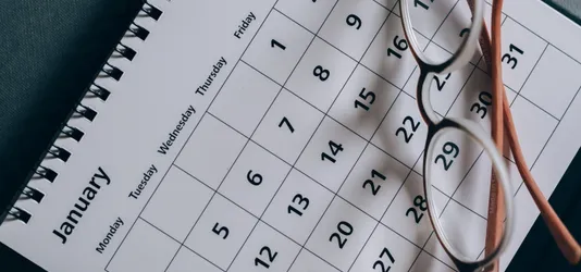 Brown-Framed Eyeglasses on a Calendar
