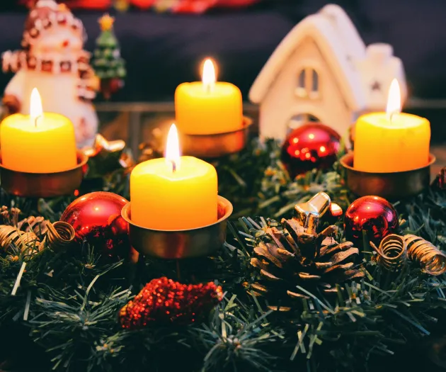 Four Yellow Lighted Candles