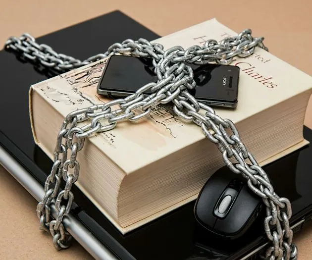 Black Android Smartphone on Top of White Book