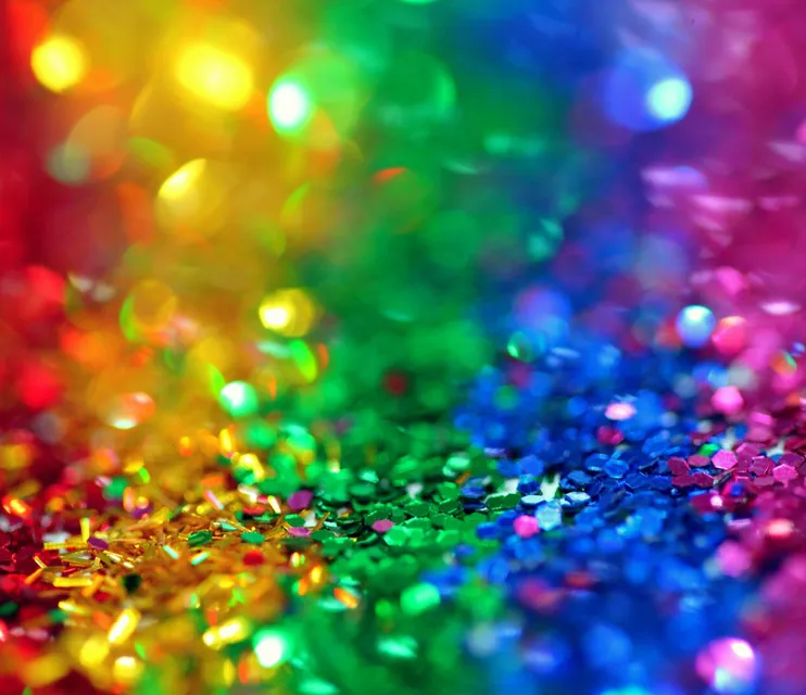 Colorful bokeh effect with vibrant rainbow glitter, perfect for festive backgrounds.