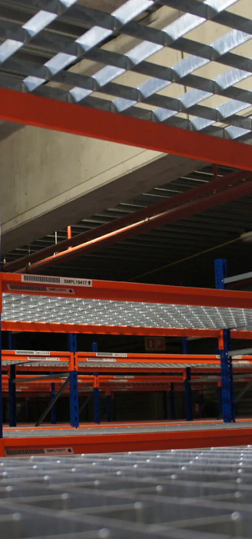 Newly painted warehouse shelving with blue columns and red beams