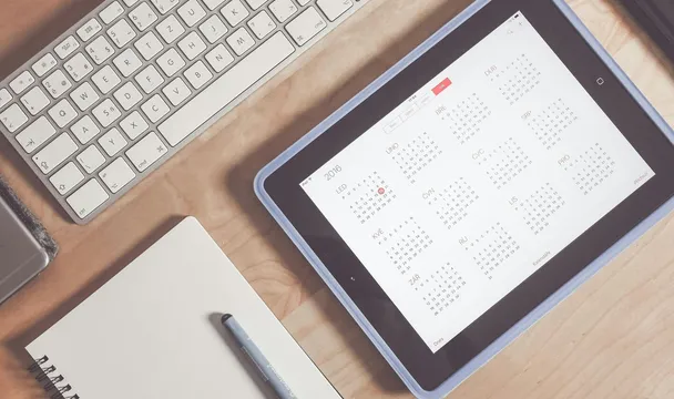 A tidy desk setup featuring a tablet displaying a