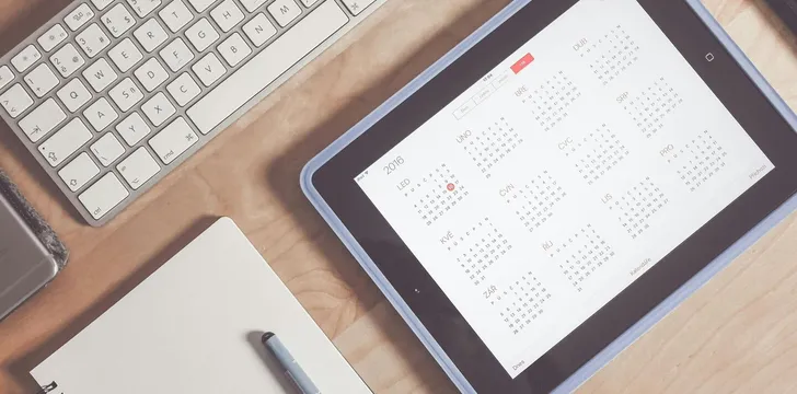 A tidy desk setup featuring a tablet displaying a