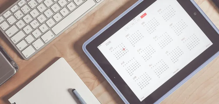A tidy desk setup featuring a tablet displaying a