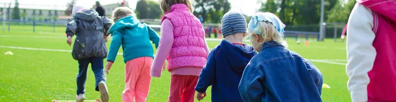Children enjoy an outdoor activity on a grassy