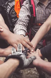 A group of diverse individuals join hands for