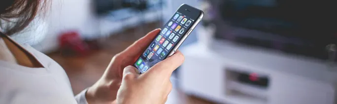 Woman browsing smartphone indoors, highlighting