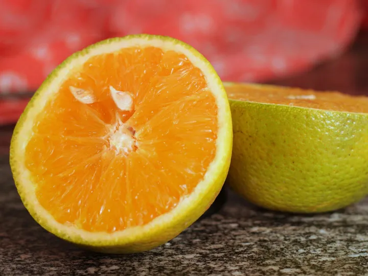 Vibrant close-up of a juicy orange sliced in half