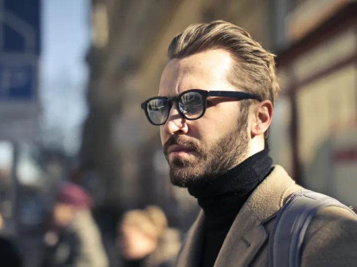Man with coat and glasses