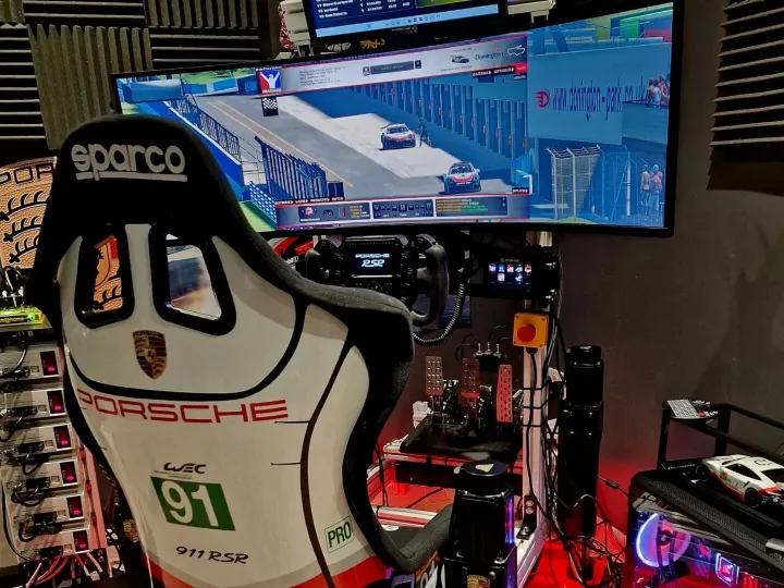 Racing sim rig view from behind with a white cockpit seat