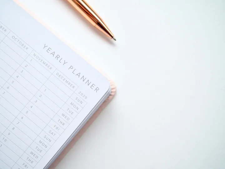 A stylish yearly planner open to a 2020 calendar