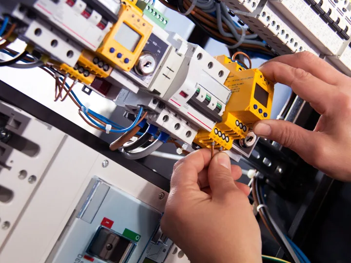 An electrician working with a fuse box