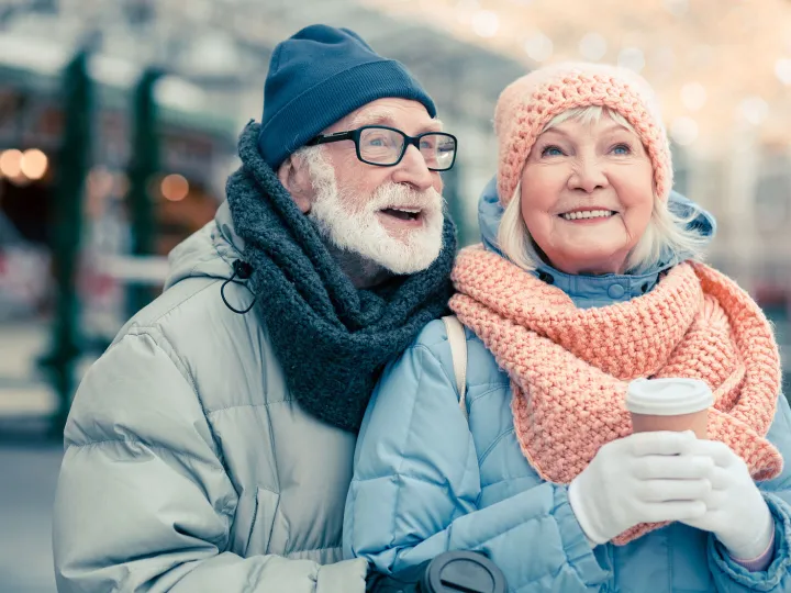 Elderly Couple Wrapped Up Warm For Winter