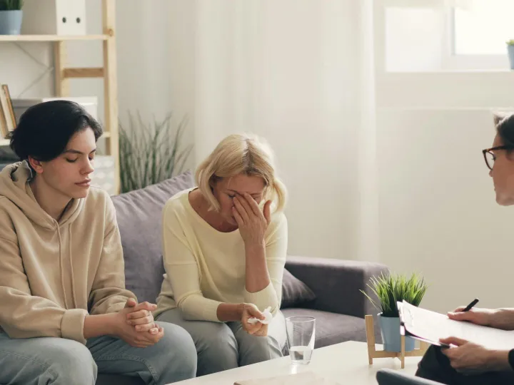 Emotional family therapy session with a therapist