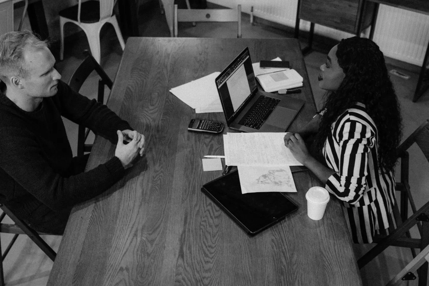 Colleagues discussing work at a table