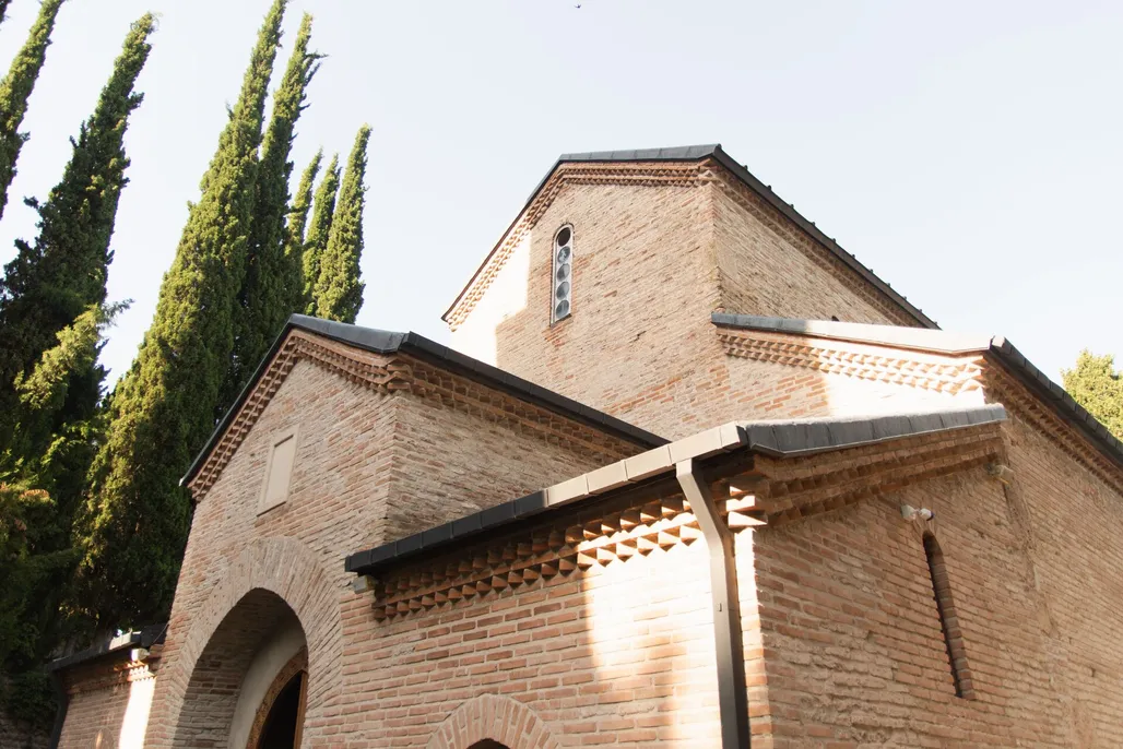 A charming brick church facade framed by tall
