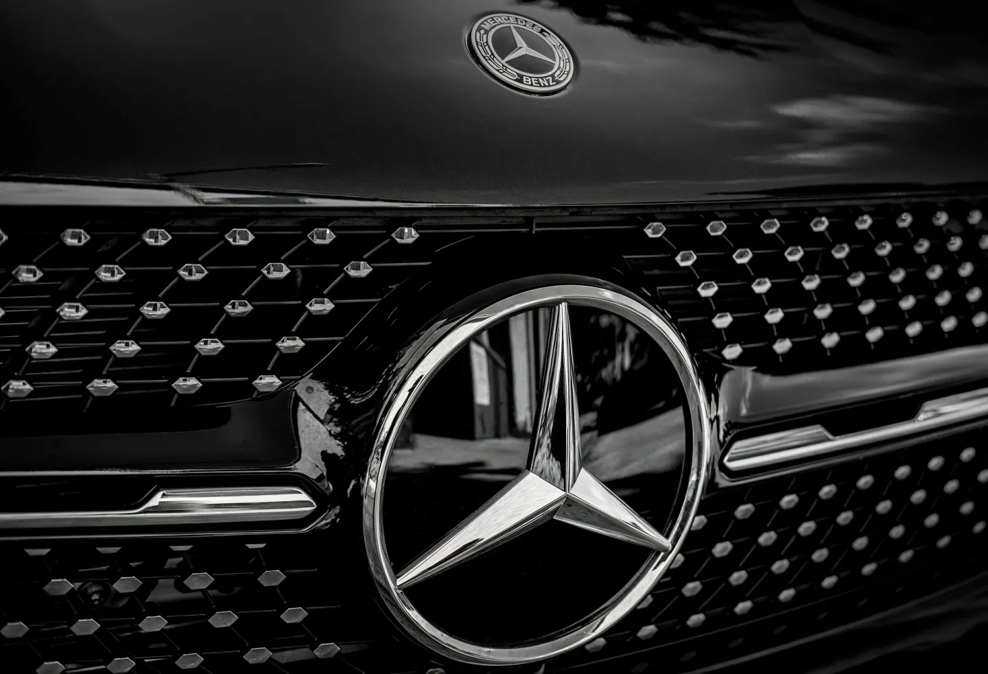 Detailed close-up of a Mercedes-Benz emblem on a