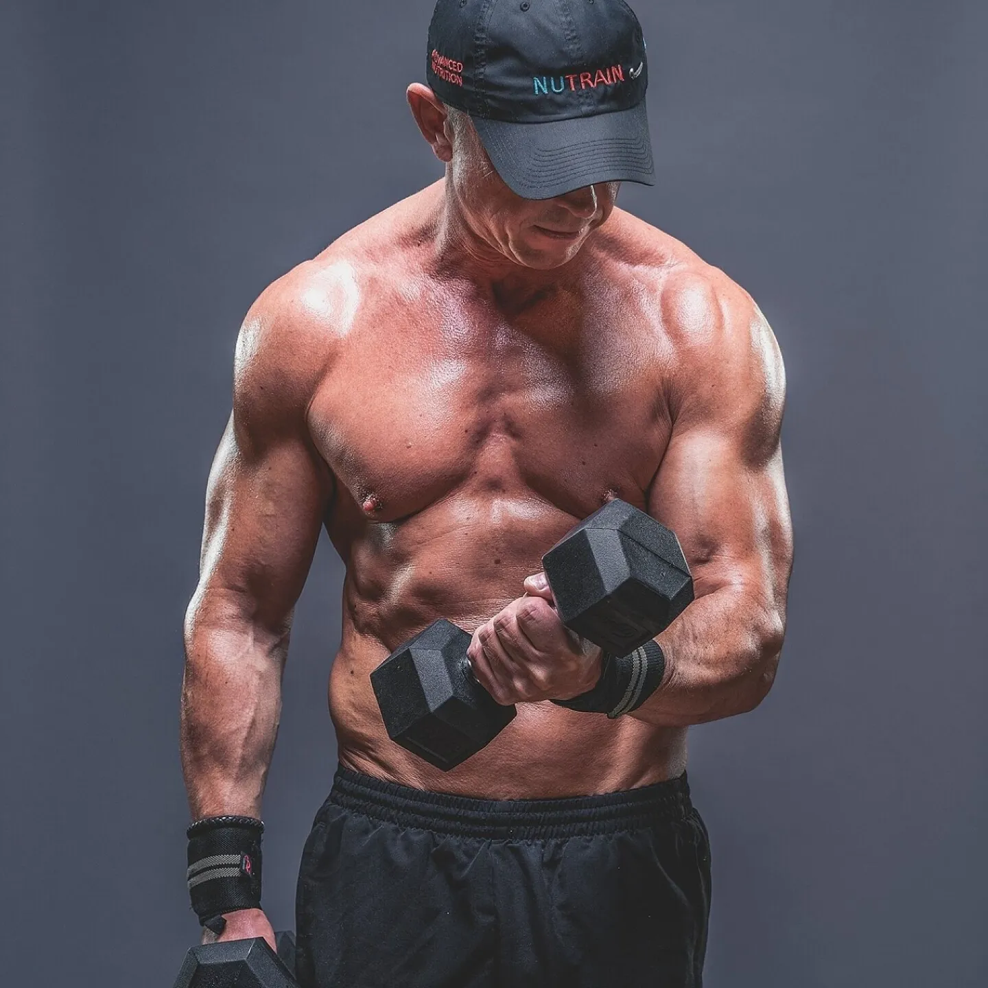 Personal Trainer Lifting Dumbbell During Strength Workout