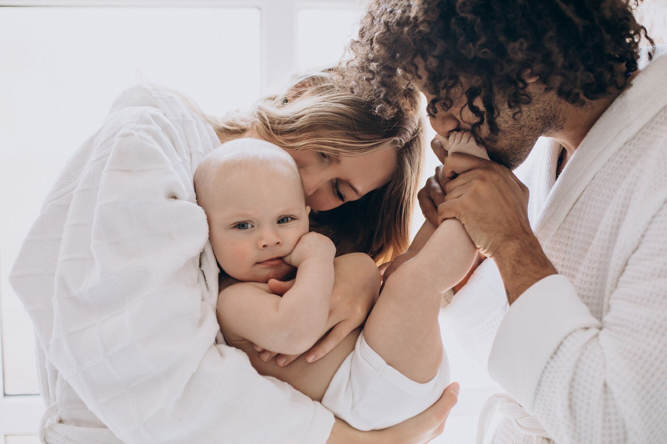 Multicultural family with their little son having
