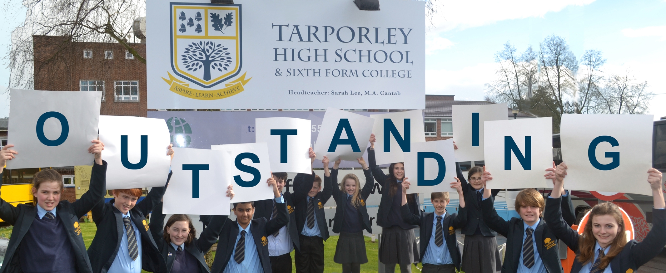 Students Holding Outstanding Letters Smaller