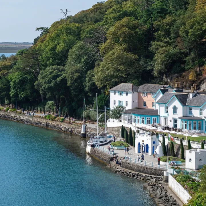 Pastel painted houses above a calm estuary in a coastal village