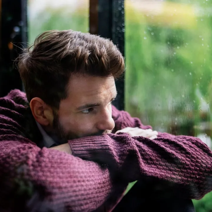 Thoughtful man looking out the window