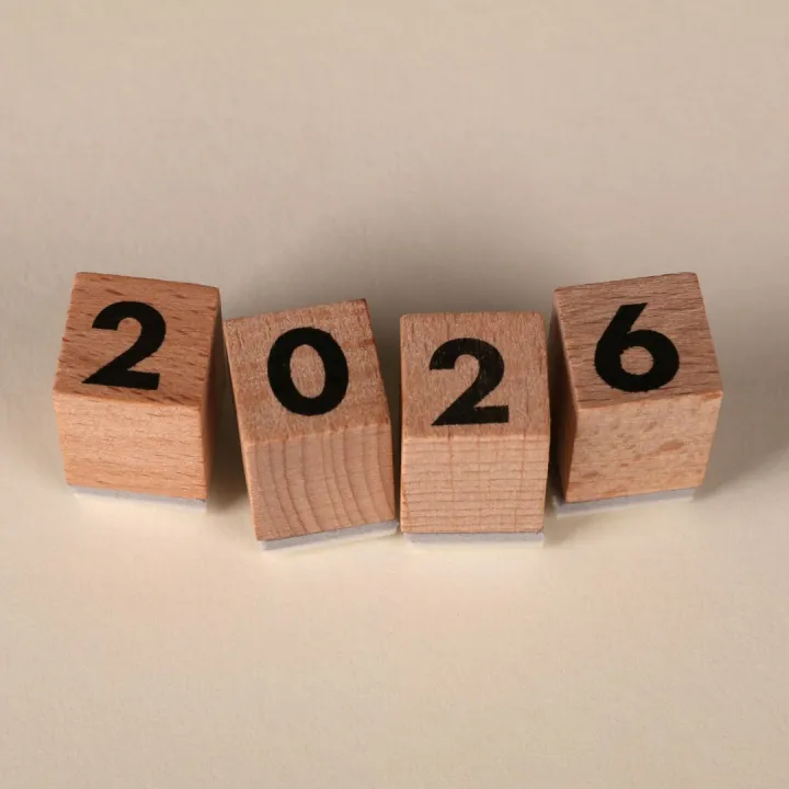 Wooden cubes forming the year 2026 on a neutral