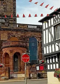 Red sandstone church and timber-framed buildings in Whitchurch, Shropshire