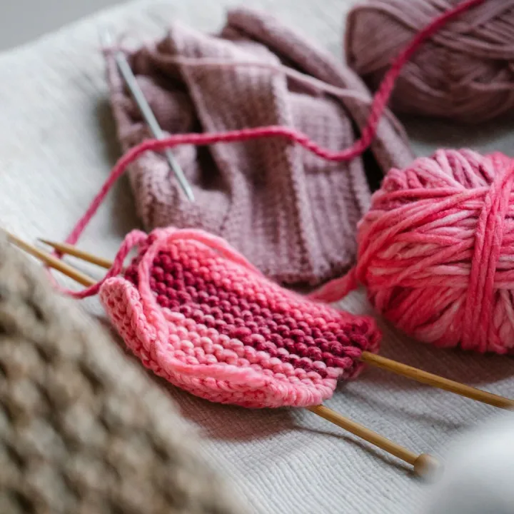 From above of knitted piece with bright pink yarn