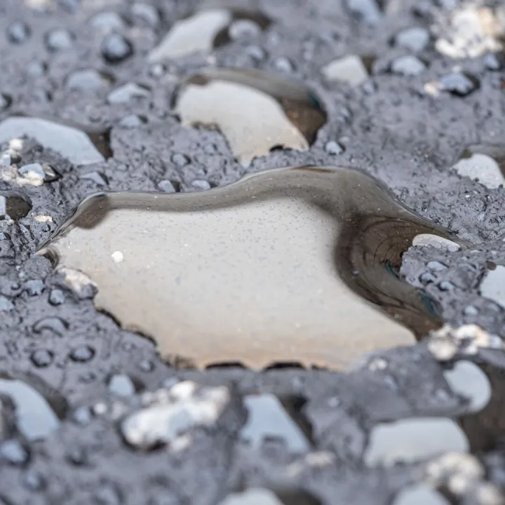 Detailed view of wet asphalt surface showing