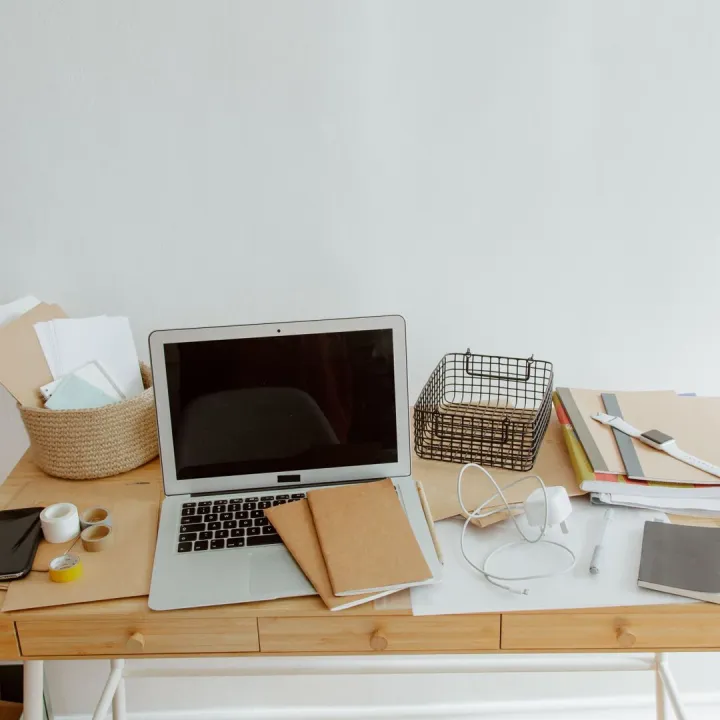 Tidy office desk with a laptop and notebooks