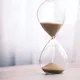 Minimalist hourglass filled with sand symbolizing