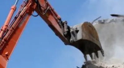 Digger demolishes building in site clearance operation