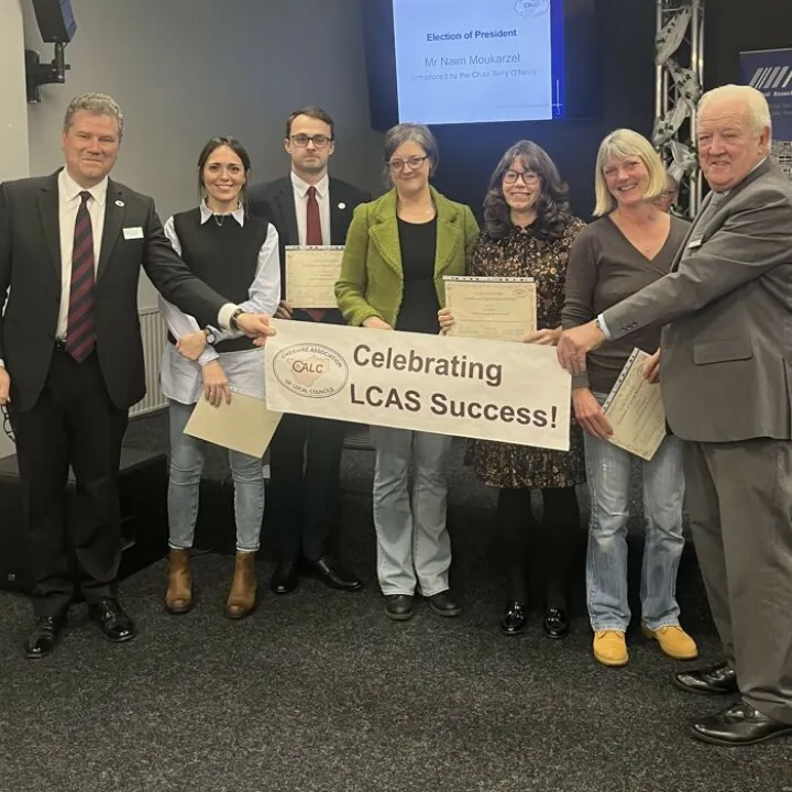 Award recipients holding certificates under a banner reading Celebrating LCAS Success!