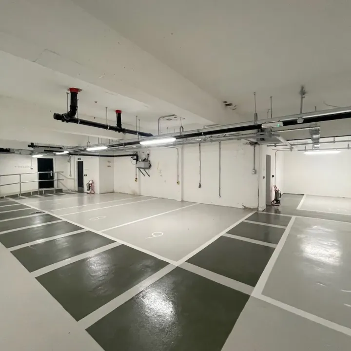 Glossy underground parking area with white markings