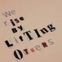 Cutout letters forming an inspirational quote on a beige background, encouraging positivity.