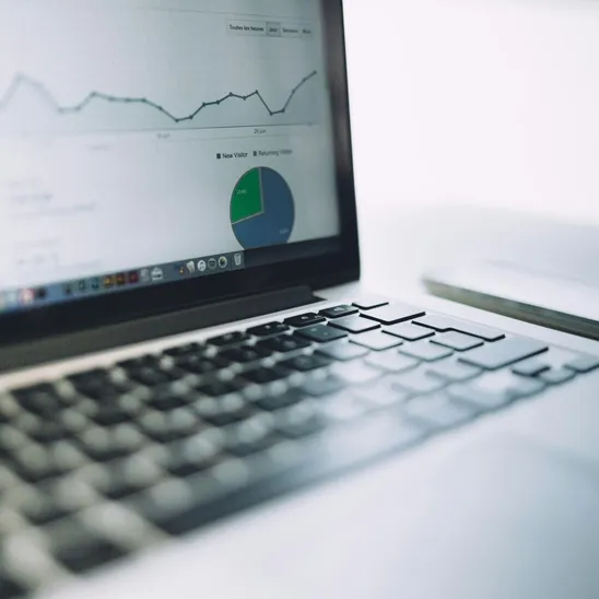 A laptop showing an analytics dashboard with