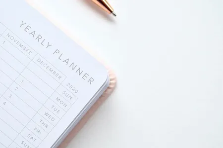 A stylish yearly planner open to a 2020 calendar