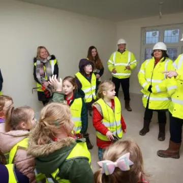 Area Sales Manager Matt Gould showing Children from Tattenhall Rainbows around the construction site at Redrow's Meadow Brook development. credit:  leeboswellphotography.com