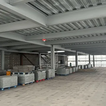 Large empty industrial space with metal roof