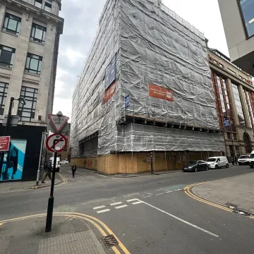 City building covered in scaffolding for renovation