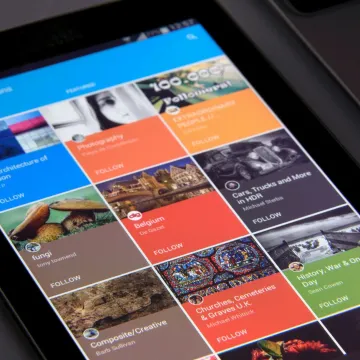Close-up of a tablet displaying diverse content collections in a grid format.