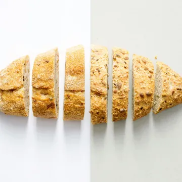 Freshly baked whole wheat bread sliced on a white 