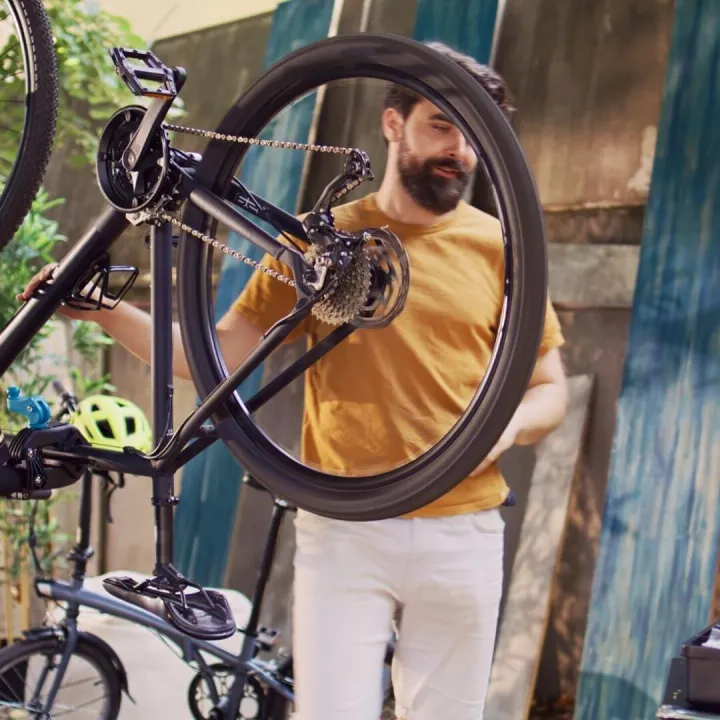 Couple repairs bicycle with work tools